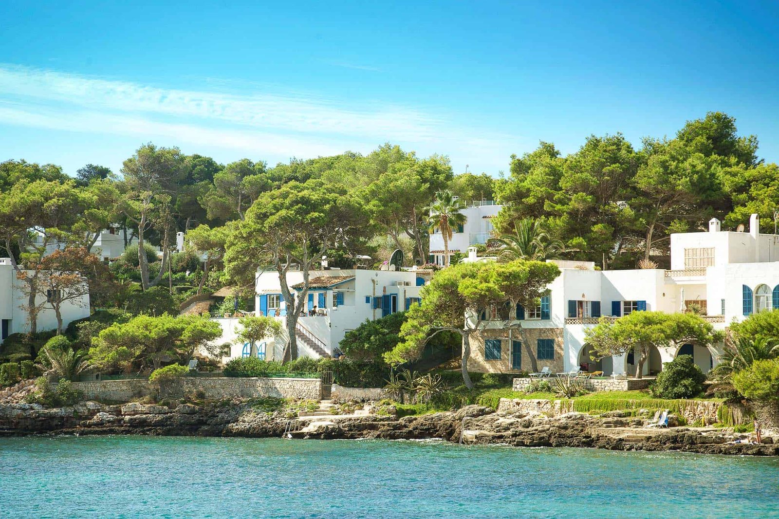 Cala Esmeralda coast with white houses and turquoise sea